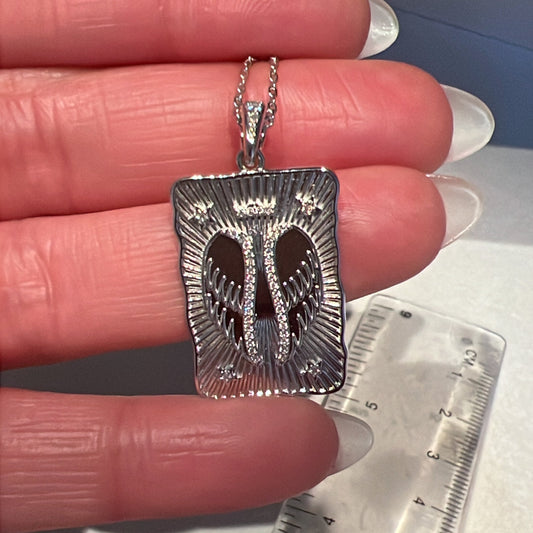 BLOOMTINE Angel Wing Necklace in tarnish-resistant sterling silver. This spiritual protection talisman features a highly detailed wing pendant on a dainty silver chain, perfect as a meaningful jewelry gift for strength and guidance, photographed against a minimalist white backdrop