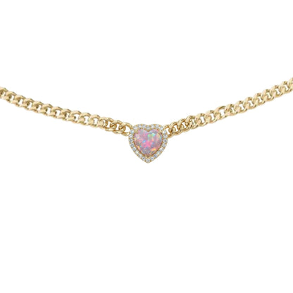 Gold necklace with a heart-shaped pink gemstone on a white background
