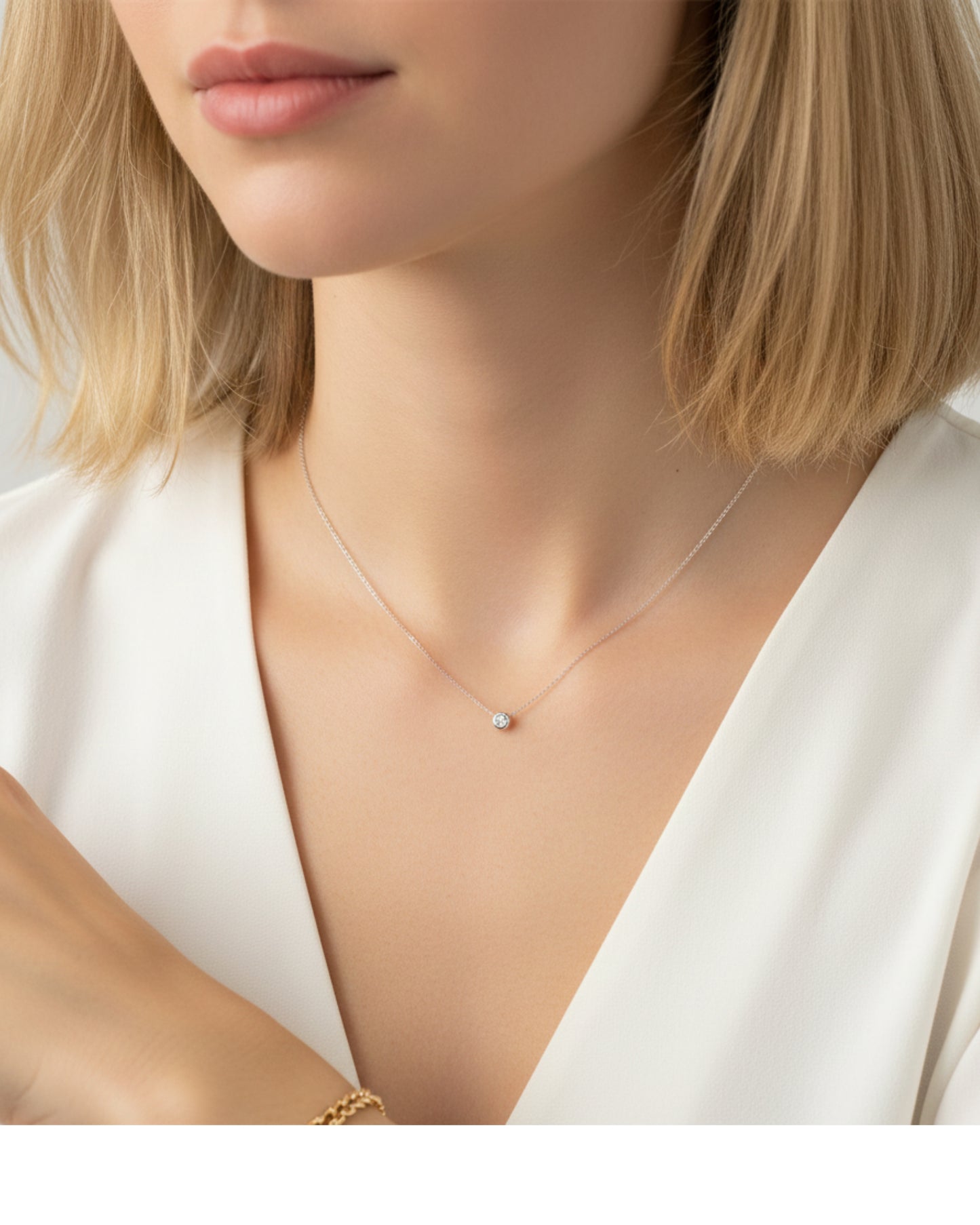 Close-up of a person wearing a delicate necklace with a small pendant.