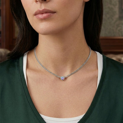 Close-up of a person wearing a necklace with a heart-shaped pendant.
