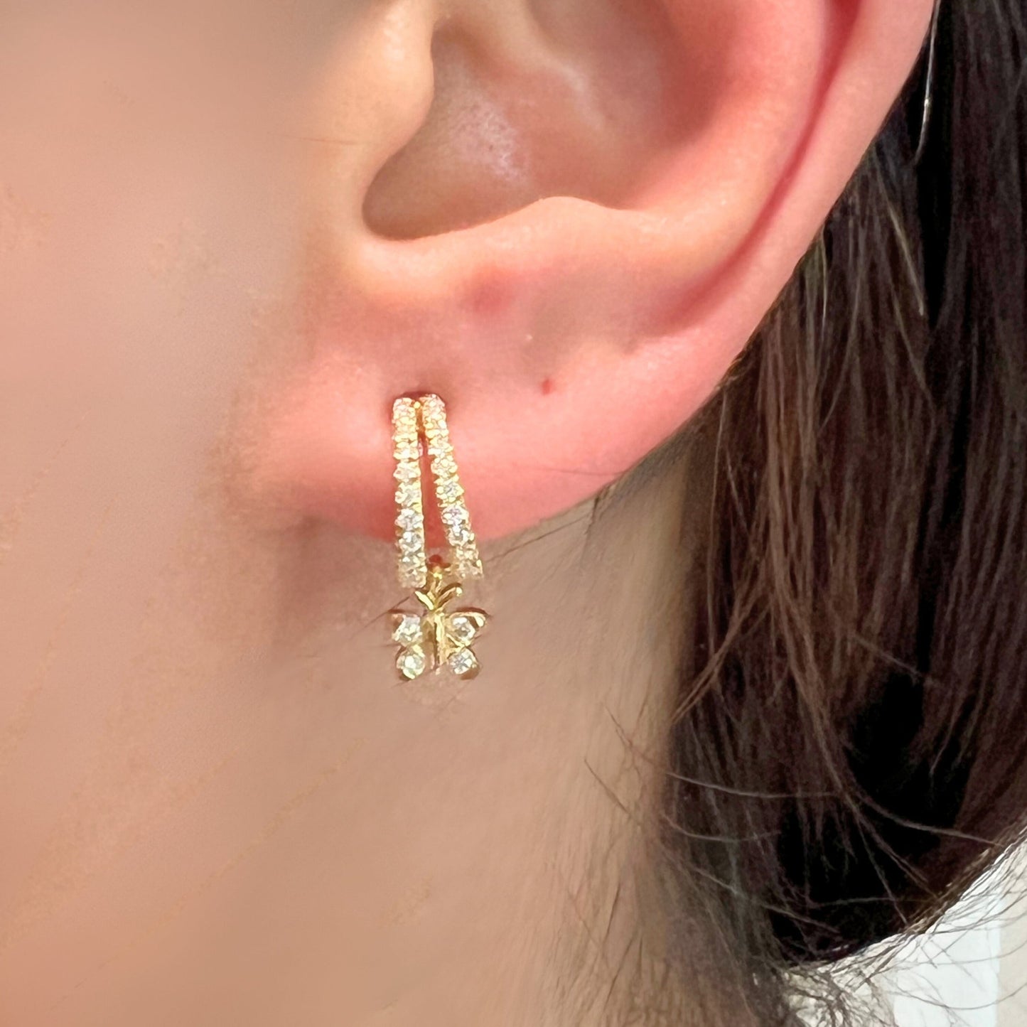 Enchanting Flutterfly™ Sterling Silver Butterfly Huggies image 5. Sterling silver butterfly huggie earrings by BLOOMTINE with a durable, mirror-like white rhodium finish. These hypoallergenic moissanite hoops offer sustainable luxury and majestic light refraction, making them the quintessential gift for meaningful milestones and new beginnings