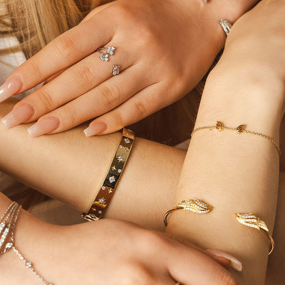 The BLOOMTINE Illuminess™ Starset Bangle in 14K Gold Vermeil. Featuring a 35g solid silver base and star-set lab moissanites, this abundance talisman is engraved with 'You are Magic' to symbolize financial flow, success, and personal empowerment