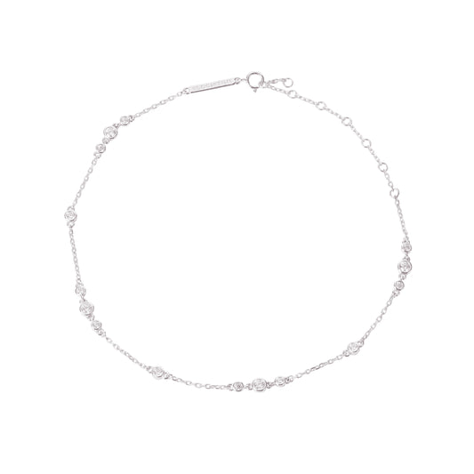 Illuminess-Premium-sterling-silver-sparkle-anklet. A professional-hero-shot of a high-quality-925-sterling-silver-anklet-featuring multiple-shimmering-gemstone designed-to-catch-the-light. The-dainty-silver-chain is displayed-on-a-clean-white-background, showcasing its-brilliant-polished-finish and delicate-craftsmanship. As-the-lead-image for the Illuminess-collection, this-sparkling-anklet represents-the-perfect-summer-accessory or bridal-gift, combining-timeless-elegance with a-modern-shimmering-