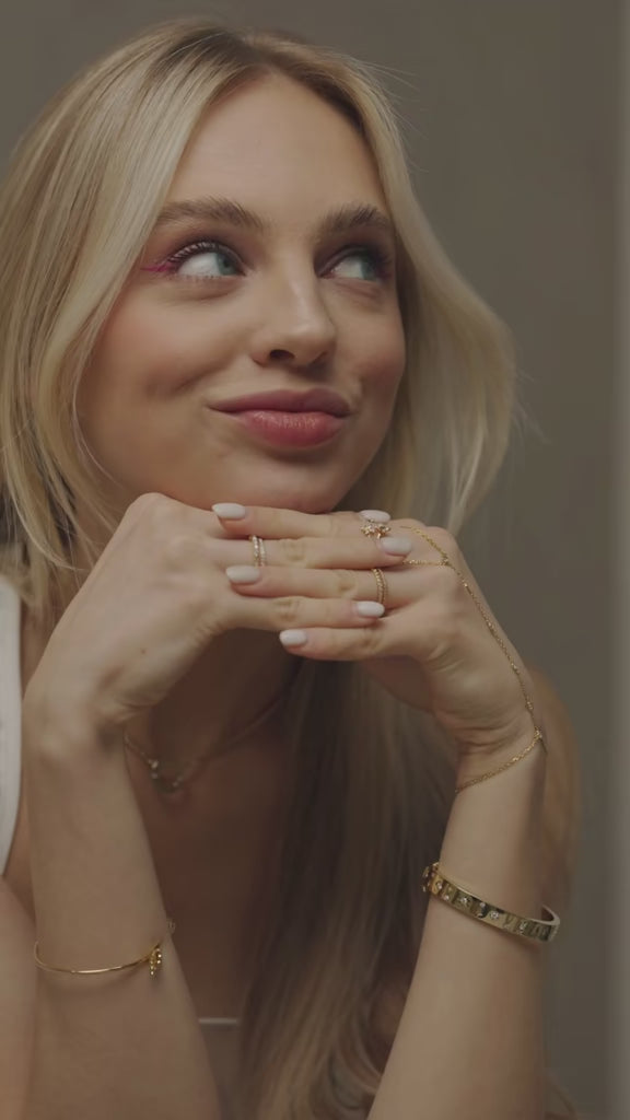 BLOOMTINE Model Showcasing Gold Gift Gift Jewellery Range. Gold Star Bangle. Gold Angel Wing Bangle. Gold Hand Chain. Gold Butterfly Ring. Gold Stacking ring. Perfect Gift Jewellery For Any Occassion